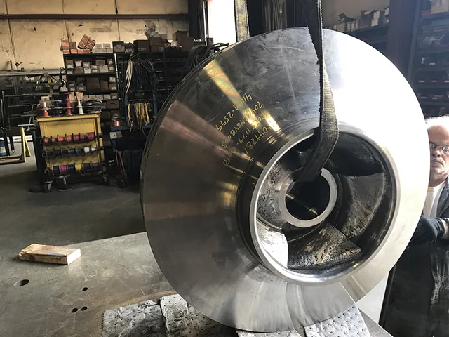 Large circular metal component with a central opening