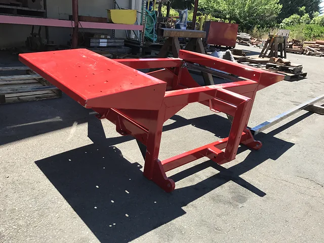 Red fabricated metal frame outdoors